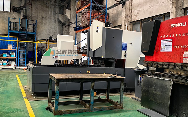 CNC punching machine processing metal sheets in workshop CNC punching machine processing metal sheets in workshop